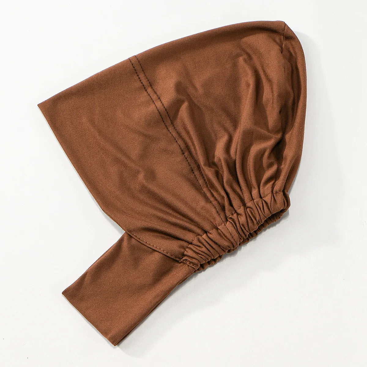Hijab foulard brun solide plié et exposé sur fond blanc.