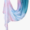 A flowing, light blue and pink printed linen hijab scarf draped elegantly.