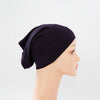 Schwarzer Bambus-Jersey-Turban-Cap auf einem Mannequin-Kopf.