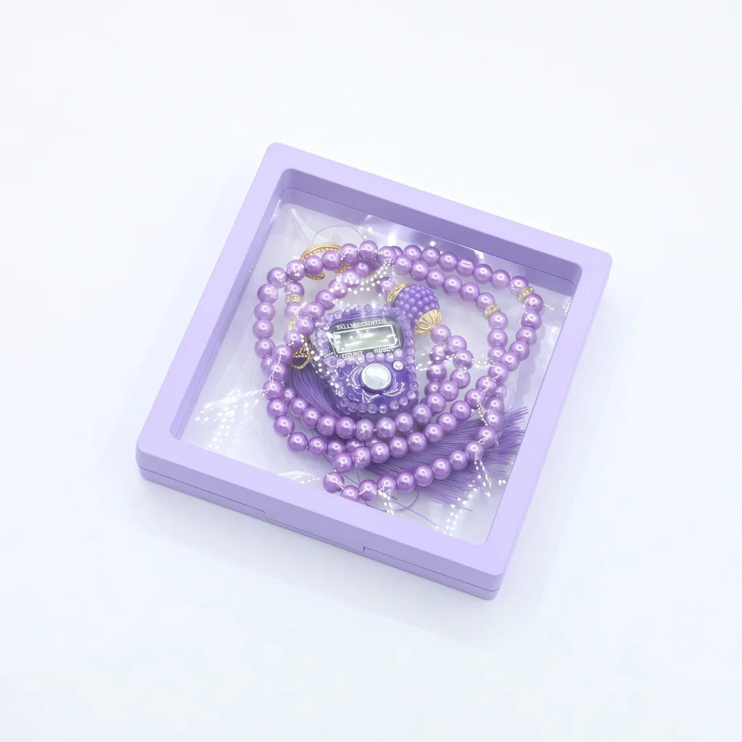 Purple prayer beads and digital counter bracelets displayed in a square clear box.
