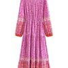 A long-sleeved pink maxi dress with floral embroidery and lantern sleeves.