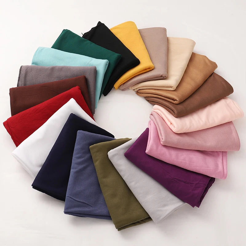 A circular arrangement of various colored premium modal jersey hijabs for women.