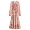 A long-sleeved, floral print maxi dress in dusty rose pink with intricate embroidery and lantern sleeves.